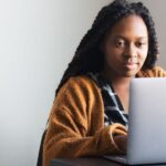 Lady sitting and working in front of a computer